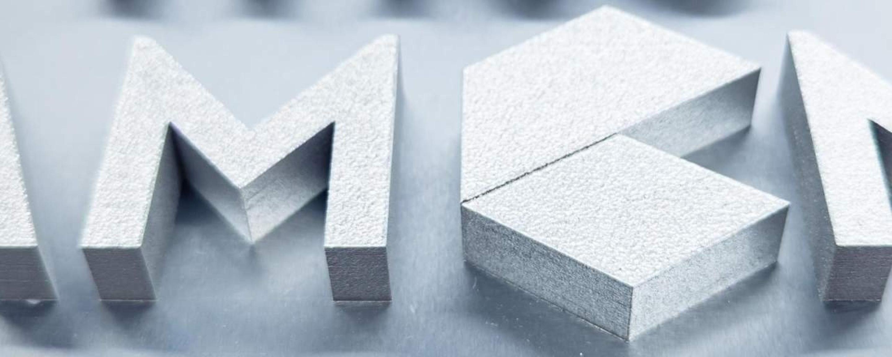 Section of a component manufactured using beam forming technology, the AMCM logo is printed in relief, the picture shows an M and the C
