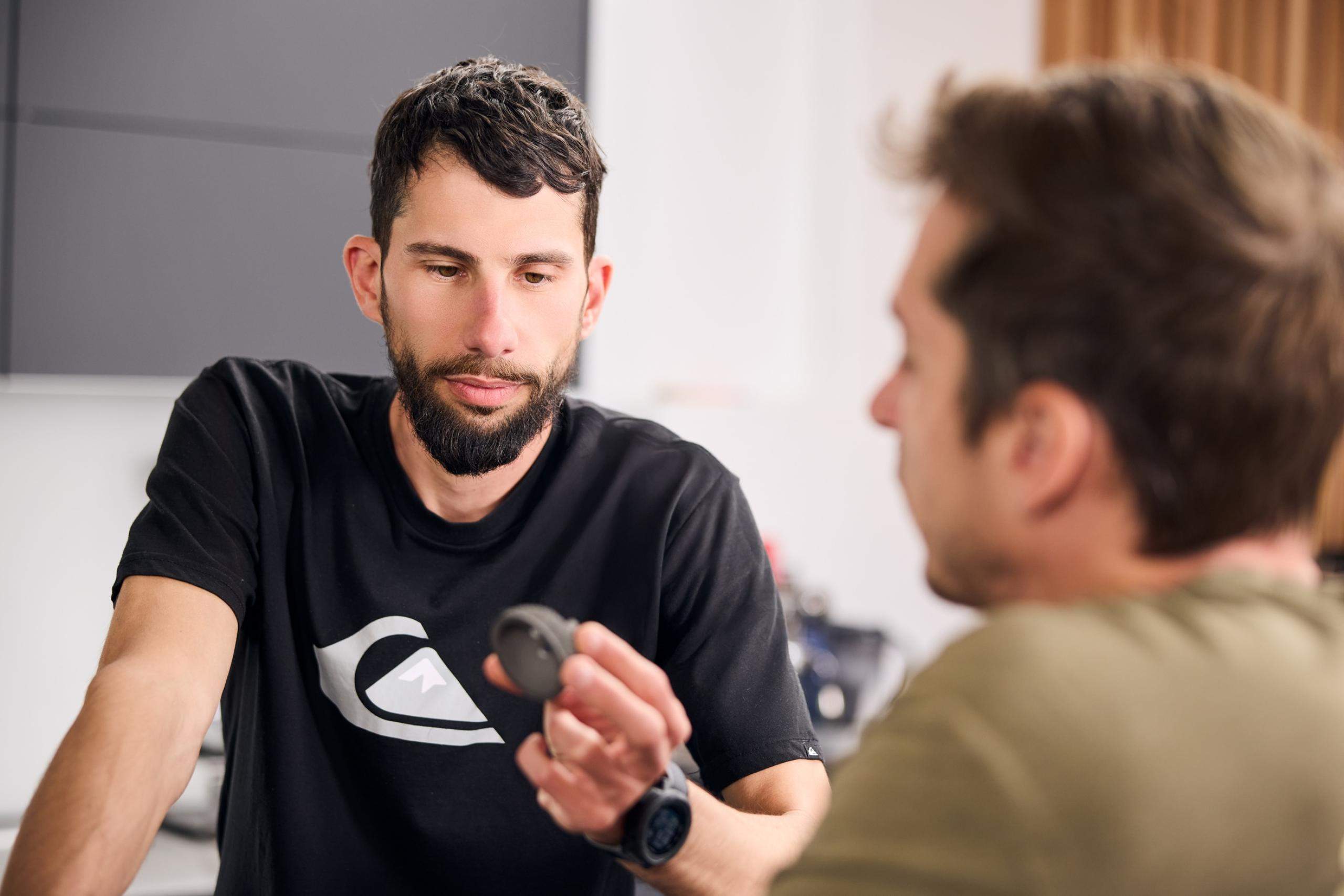 AMCM Technicians Discussing a Small 3D-Printed Component